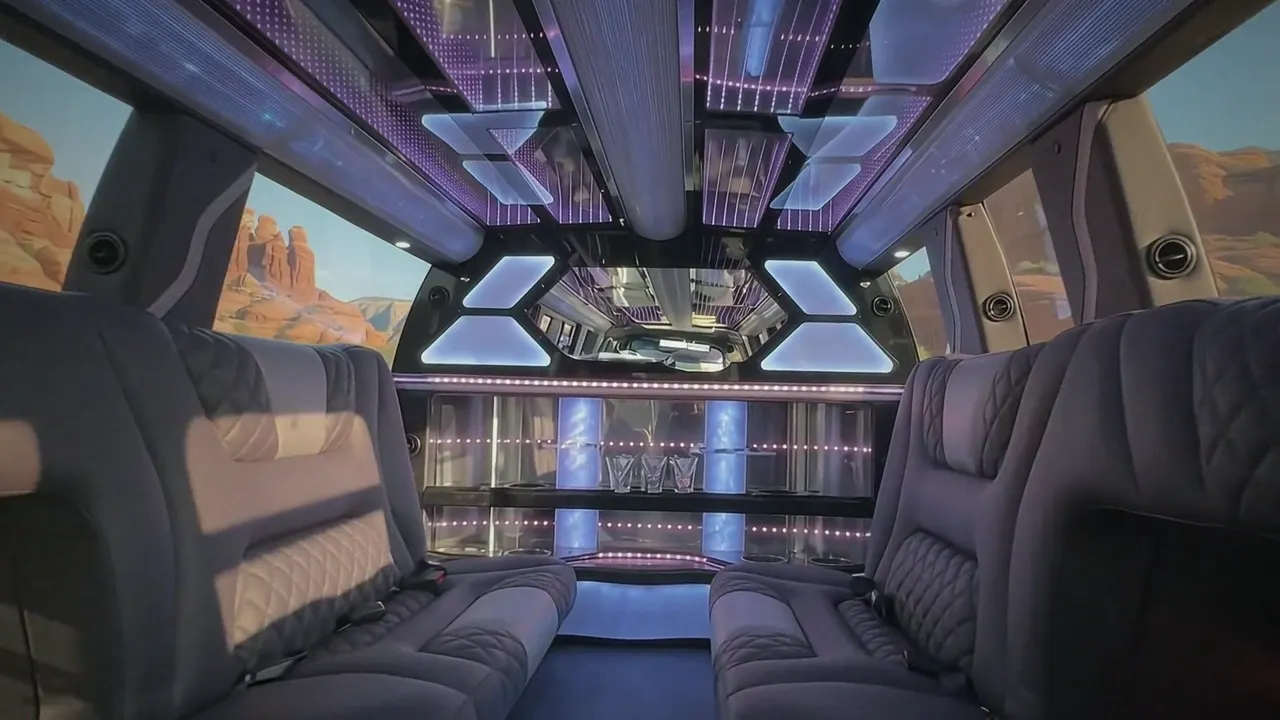Inside the Cadillac Escalade limo in Laporte: LED light-show ceiling, leather lounge seating and lit bar